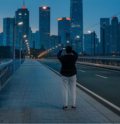 A pixelated image of an orange and white cat lying down, looking to the side, with blurred greenery in the background